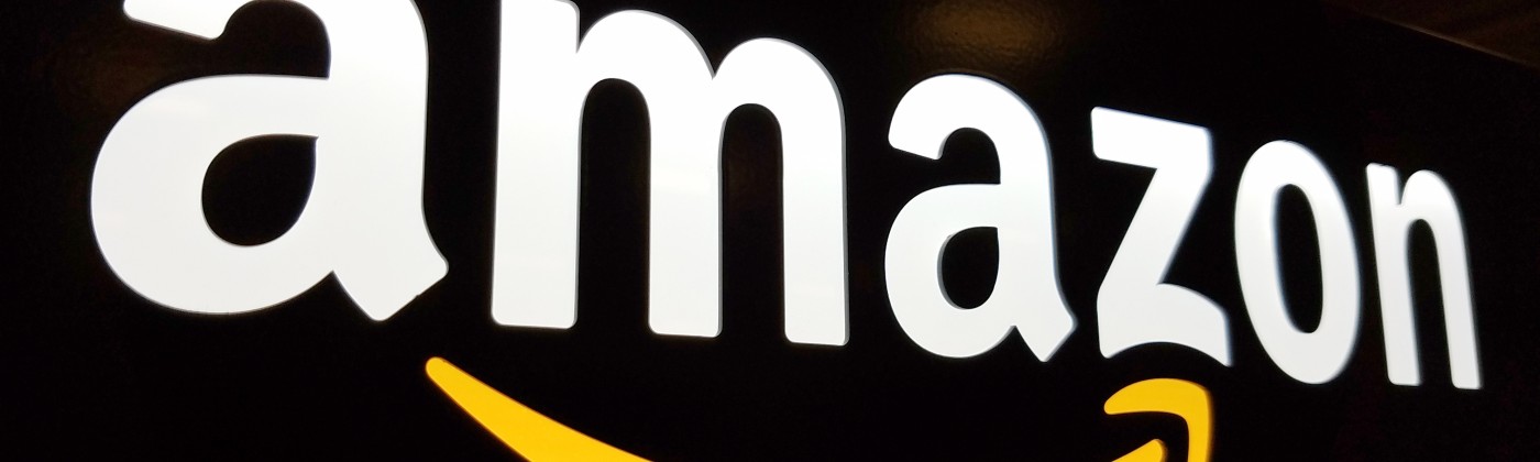 Amazon's logo on a dark, reflective surface